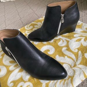 Black leather booties with zip.